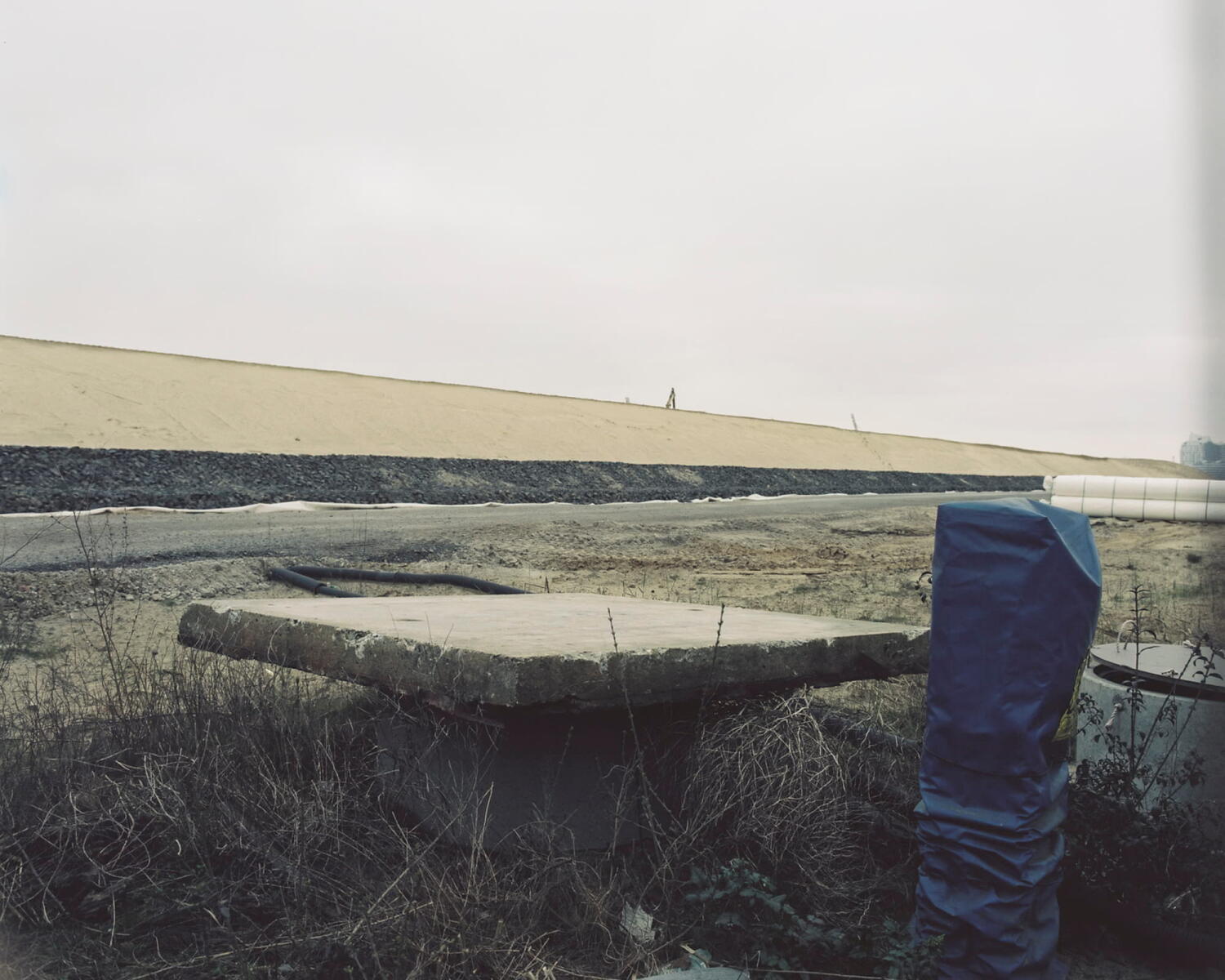 Cement and blue plastic on a building site.