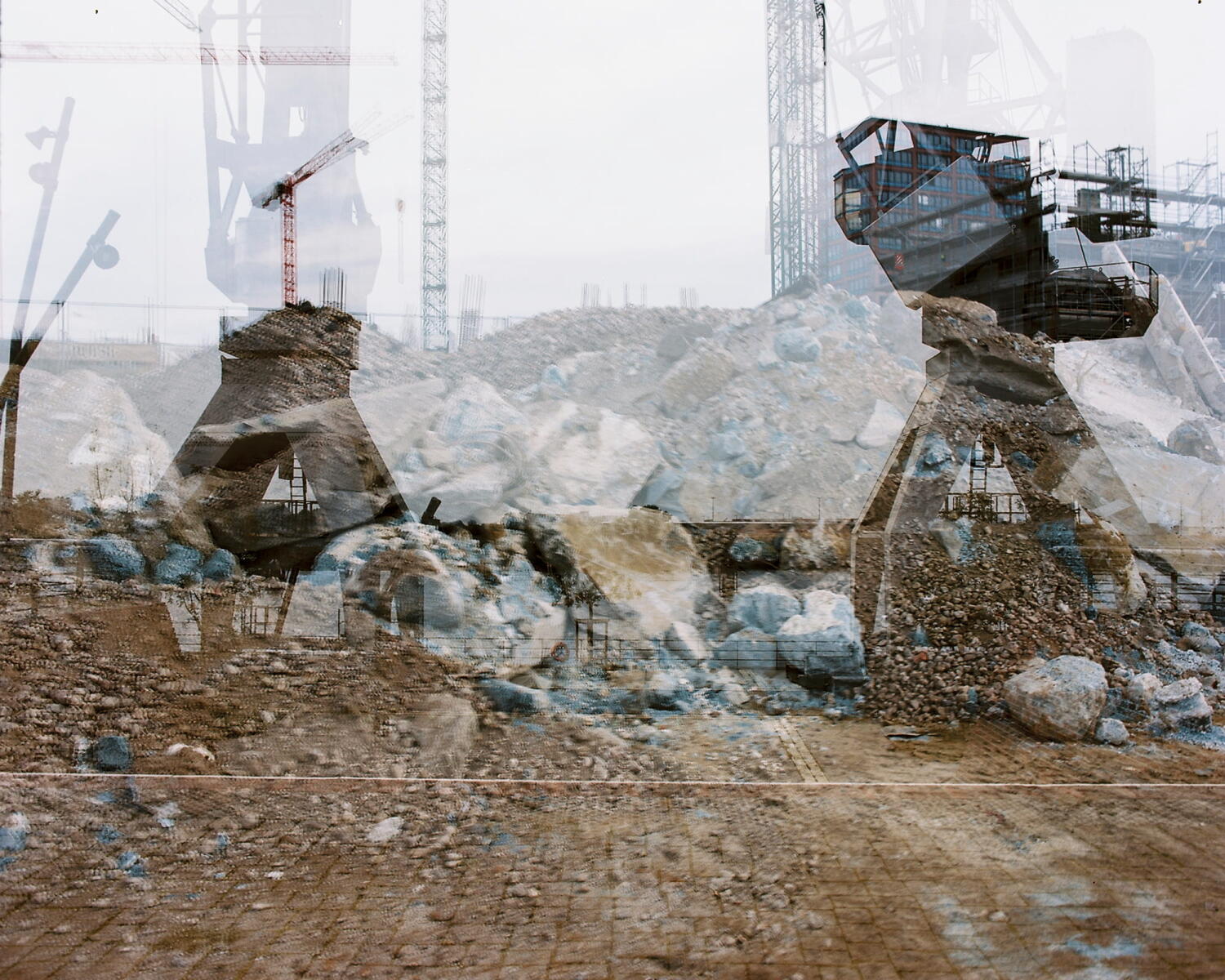 Double exposure of crane and building materials on a building site.