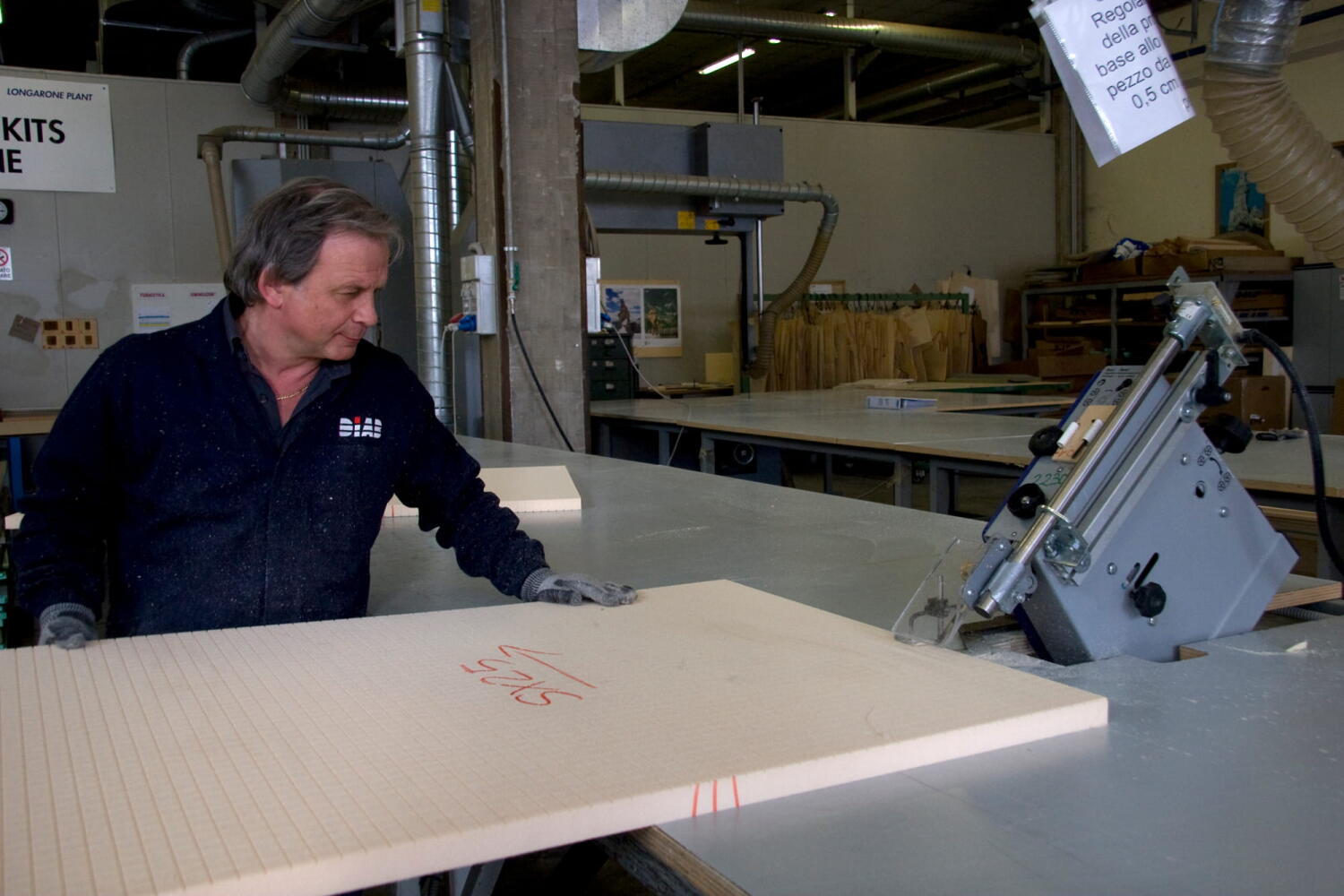 Workers cutting materials at the Diab factory, which specializes in core materials for composite materials (sandwich technology) for industries such as marine, wind energy, and aviation.