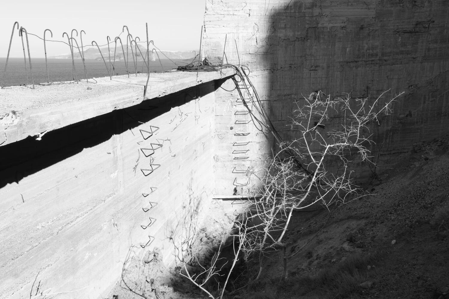 Stairs with the shadow of a plant. Fragments of a porcelain mine that has been frozen in time on an island in the Mediterranean.