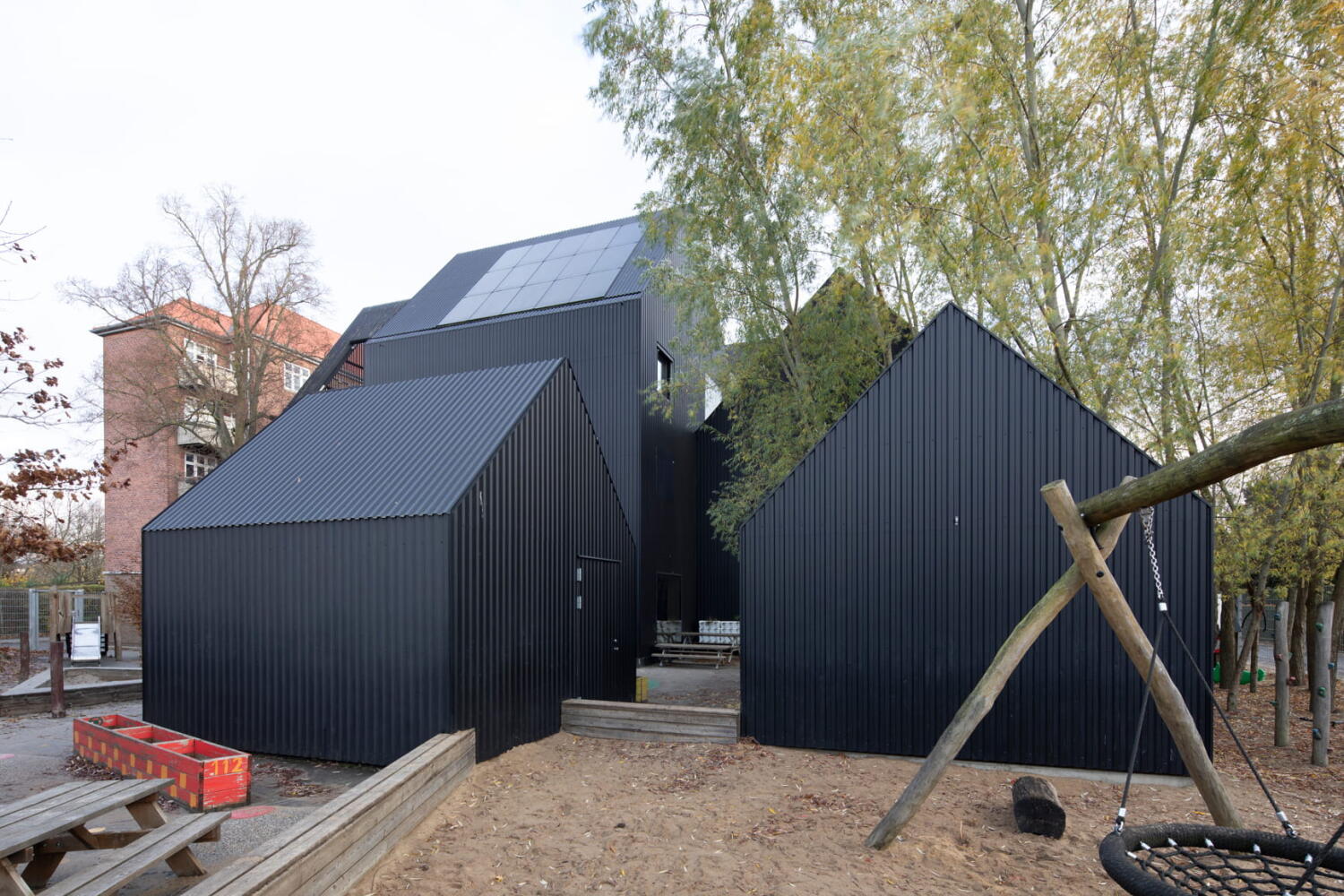 Based on the concept of a playhouse for children, Frederiksvej Kindergarten extends in black and white volumes. Frederiksvej Kindergarten by Cobe Architects in Copenhagen.