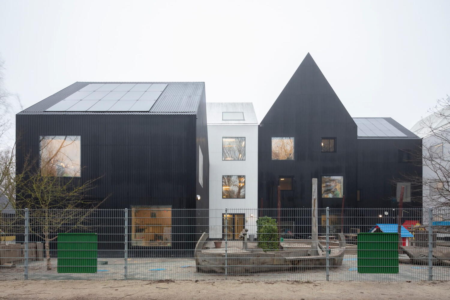 Based on the concept of a playhouse for children, Frederiksvej Kindergarten extends in black and white volumes. Frederiksvej Kindergarten by Cobe Architects in Copenhagen.