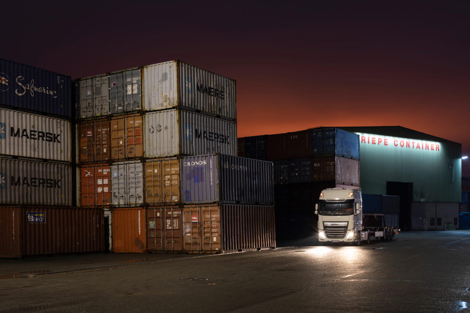 Pile of containers and a camion from the “Night Beasts” series. At night, these industrial installations transform into fantastical creatures that form a bestiary.