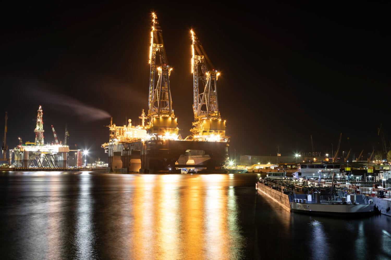 Cranes on a ship and their reflections from the series “Night Beasts.” During the night, these industrial installations transform into fantastic creatures that form a bestiary.