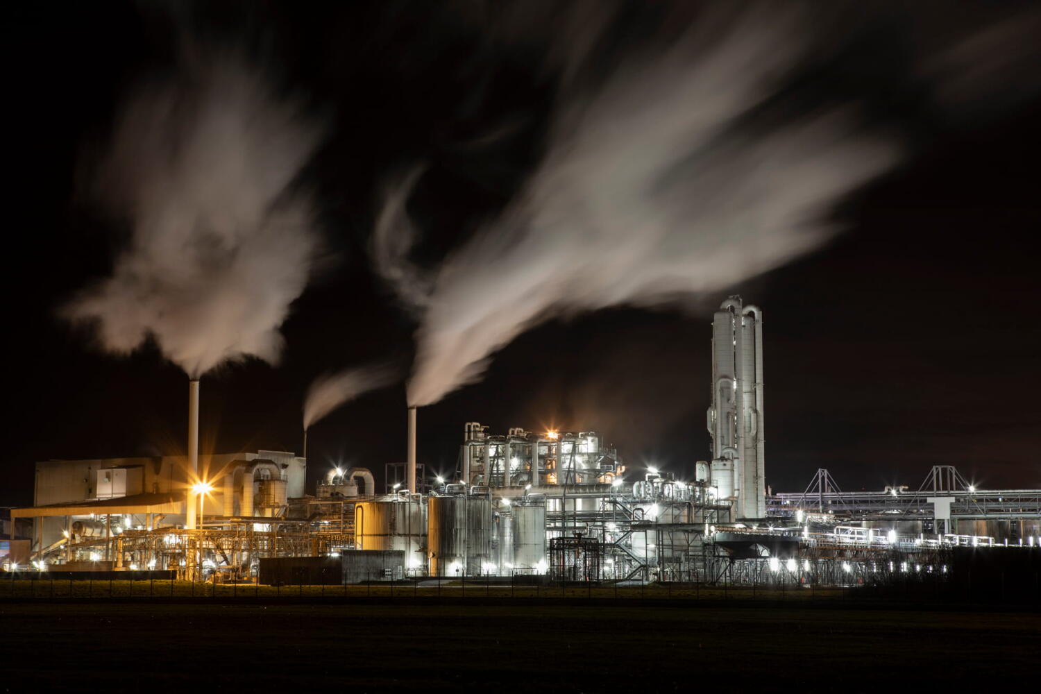 Night landscape of a factory and its smoke clouds from the series “Night Beasts.” During the night, these industrial facilities transform into fantastic creatures that form a bestiary.