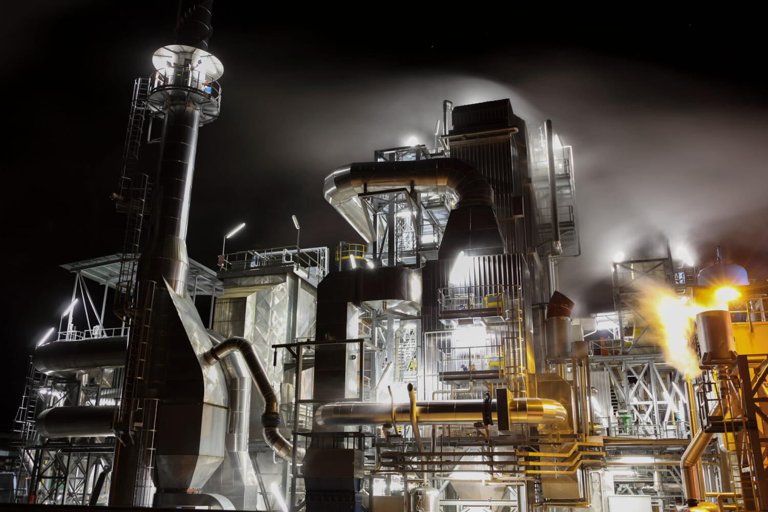 Night landscape of a factory and its smoke clouds from the series “Night Beasts.” During the night, these industrial facilities transform into fantastic creatures that form a bestiary.