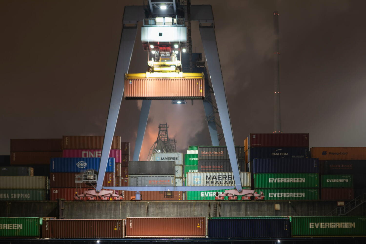 Crane moving containers in an Harbour from the “Night Beasts” series. During the night, these industrial installations transform into fantastic creatures that form a bestiary.