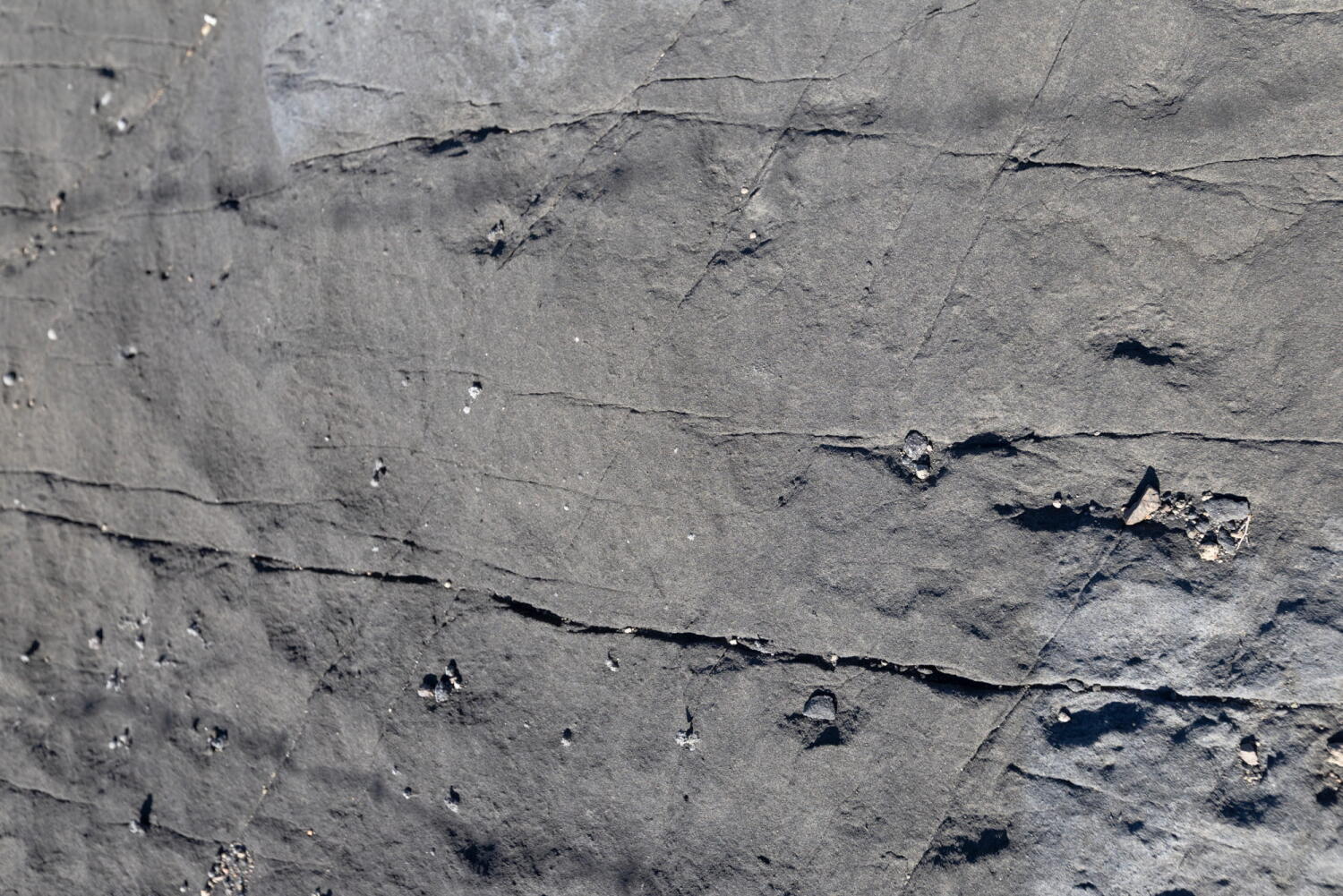 Textured surface of a porcelain mine that has been frozen in time on an island in the Mediterranean.