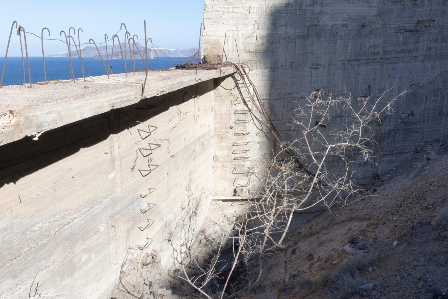 Stairs with the shadow of a plant. Fragments of a porcelain mine that has been frozen in time on an island in the Mediterranean.